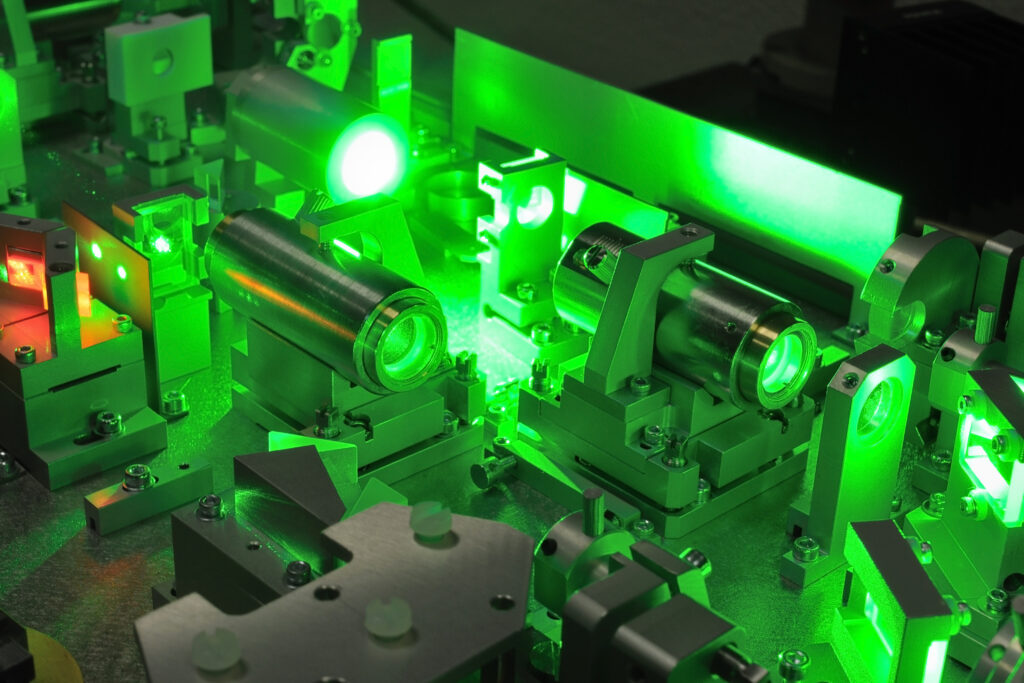 bright green laser light going inside complicate scientific system;
selective focus on central part of image